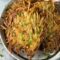 A plate of potato latkes garnished with sliced green onions