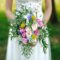 Bride holding bouquet of various colored flowers