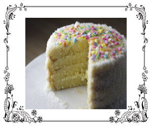 A white layer cake with pastel sprinkles on top.