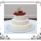 A white cake with red flower topper