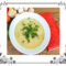Bowl of potato soup with parsley garnish.