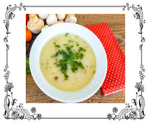 Bowl of potato soup with parsley garnish.