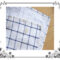A checkered dishtowel with a stain.