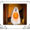 Dog dressed as ghost holding carved pumpkin treat basket