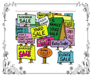 Various types of signs pointing to a garage sale