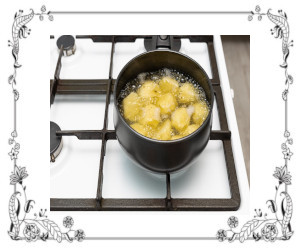 A pot of boiling potatoes on a stove.