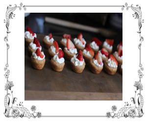 whipped cream topped tarts with a strawberry