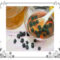 Raisins soaking in bowl of water and scattered on table