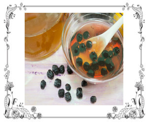 Raisins soaking in bowl of water and scattered on table