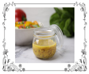 A cruet of honey mustard salad dressing
