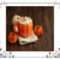 Pumpkin latte in a pumpkin-shaped cup with 3 little pumpkins beside the cup.
