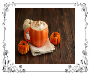 Pumpkin latte in a pumpkin-shaped cup with 3 little pumpkins beside the cup.